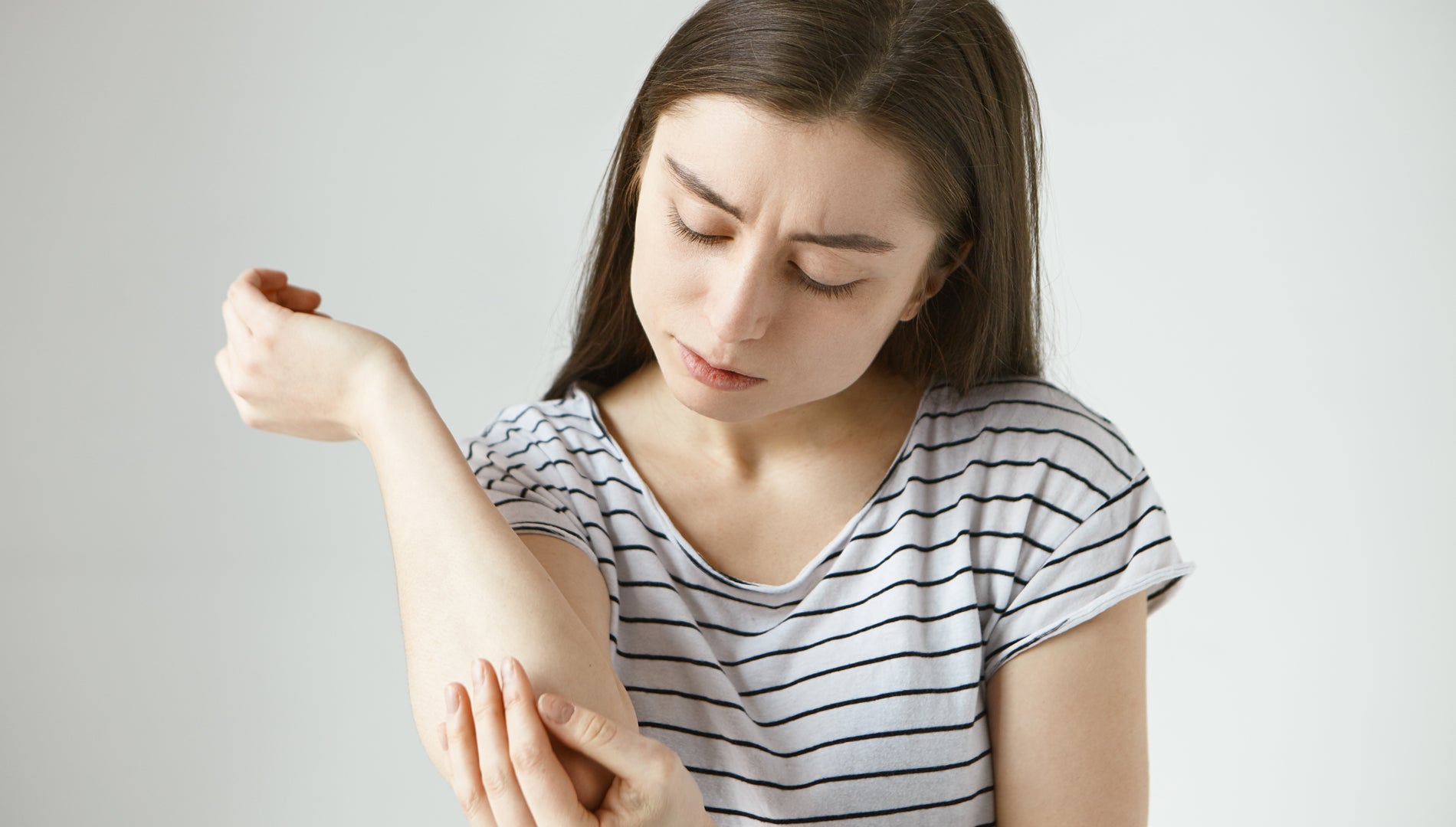 Young girl watching her Dry skin of hand